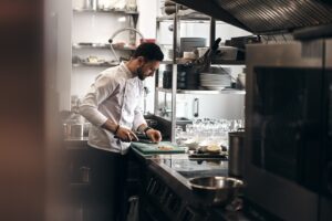 A chef dressed in a white coat working in a kitchen.
@novokayn on Instagram