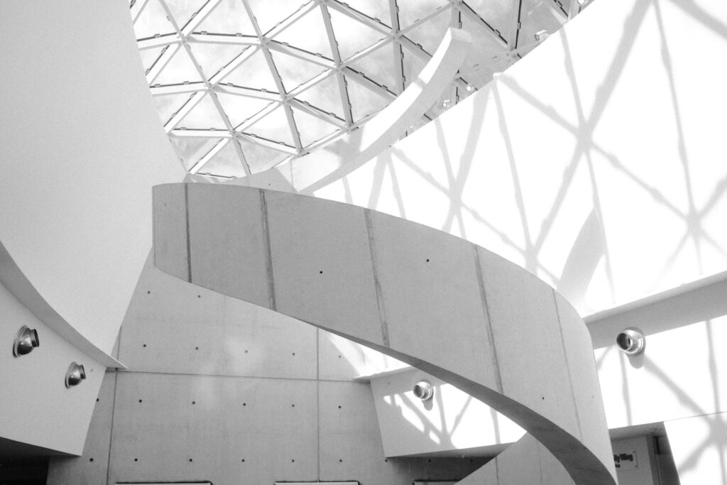 a black and white photo of a spiral staircase
