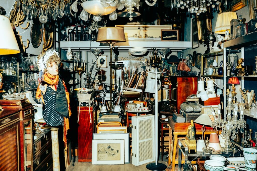 Cluttered antique shop filled with lamps and furniture.