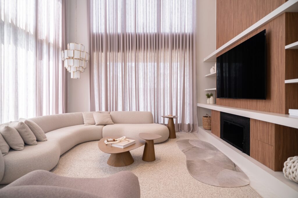 Modern living room with curved sofa and large windows