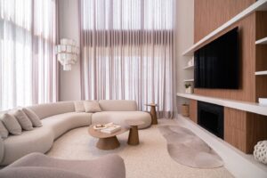 Modern living room with curved sofa and large windows