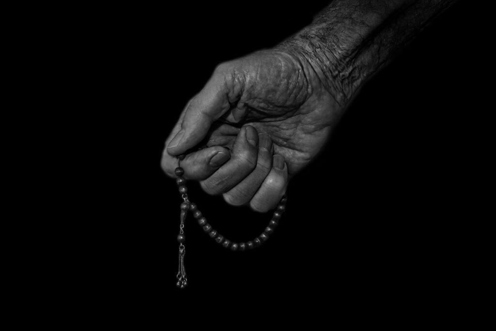 Hand holding prayer beads