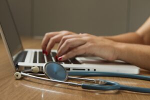 Stethoscope and Laptop Computer. Laptop computers and other kinds of mobile devices and communications technologies are of increasing importance in the delivery of health care. Photographer Daniel Sone